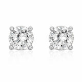 Studio view of a pair of round silver tone stud earrings featuring cubic zirconia stones secured in classic four prong settings.