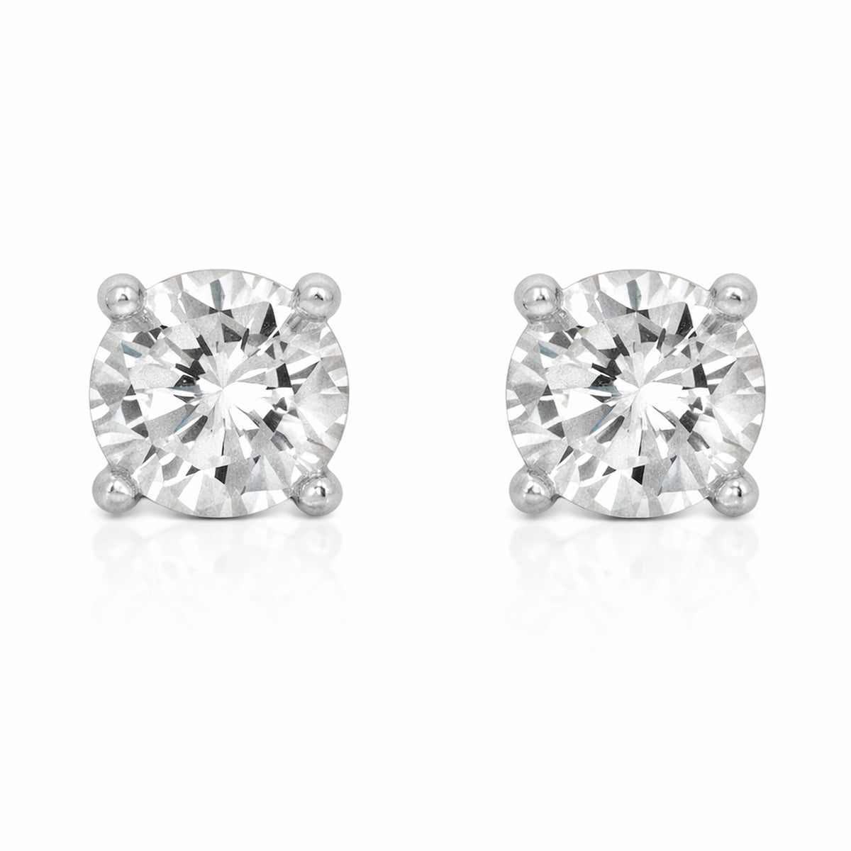 Studio view of a pair of round silver tone stud earrings featuring cubic zirconia stones secured in classic four prong settings.