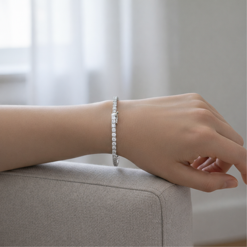 Tennis bracelet worn on the wrist, showcasing its elegant fit, slim profile, and timeless line of round cut cubic zirconia stones in a silver tone finish.