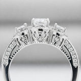 Side profile view of the three stone halo cubic zirconia ring highlighting the gallery details and pavé set shoulders.
