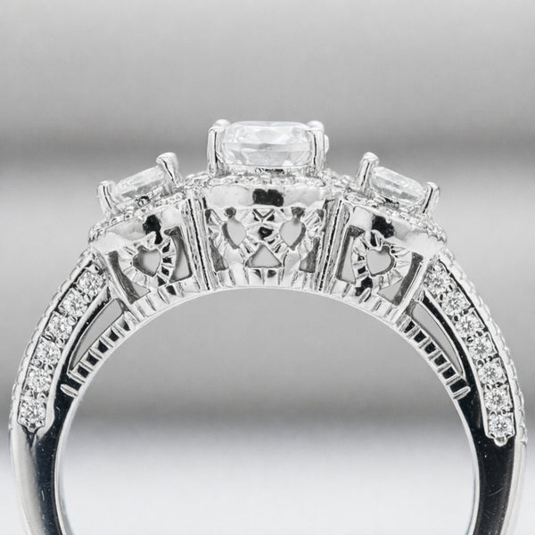 Side profile view of the three stone halo cubic zirconia ring highlighting the gallery details and pavé set shoulders.
